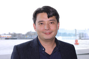 man on bridge in suit with black hair