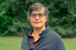 woman outside with short hair and glasses