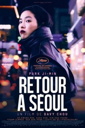 A film poster featuring a woman in a black jacket walking through a busy, neon-lit street at night, glancing back over her shoulder. The title "Retour à Séoul" appears boldly, with festival awards including Cannes.